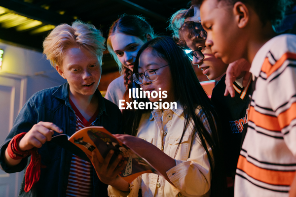 young people looking at book